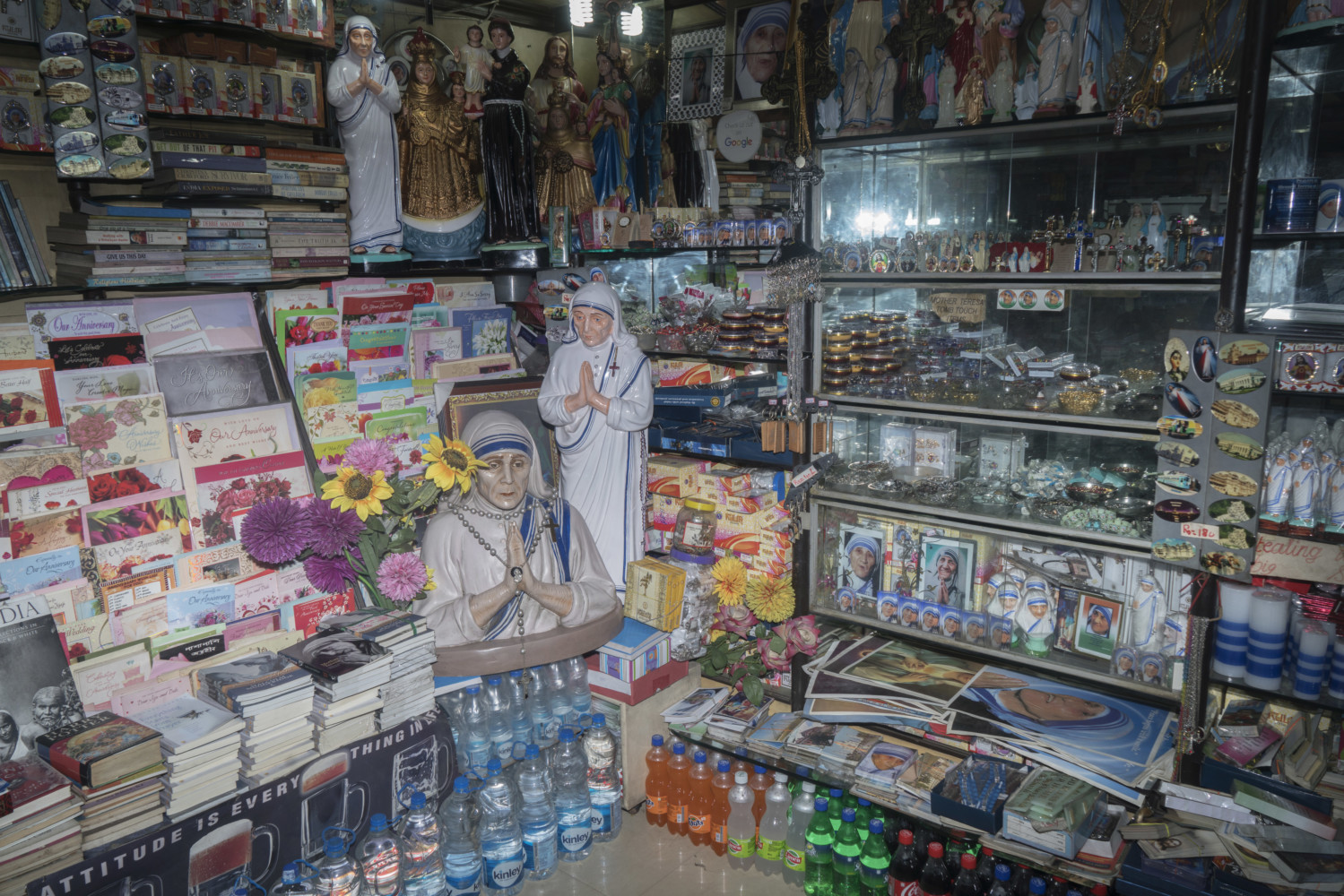 From the Magnum Photos Website: Souvenir shop dedicated to Mother Teresa. It is widely expected that the canonisation of Mother Teresa will lead to larger numbers of foreign tourists inflow and the Indian Association of Tour Operators has urged the West Bengal State Government to promote Kolkata's links to Mother Teresa so as to take advantage of the tourism opportunities. Kolkata, India August 2016. © Sohrab Hura / Magnum Photos.